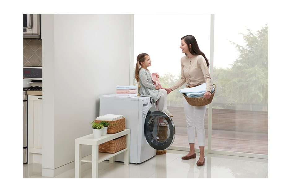 /ae/lg-story/helpful-guide/the-best-dryer-machine-you-can-buy-for-your-home/Mom and son sitting on the floor in front of LG dryer